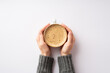 Leinwandbild Motiv Autumn concept. First person top view photo of female hands in grey sweater holding cup of hot drinking on isolated white background