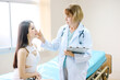 © topkritsada - Beautiful Asian woman consulting a cosmetologist for cosmetic surgery in a clinic.