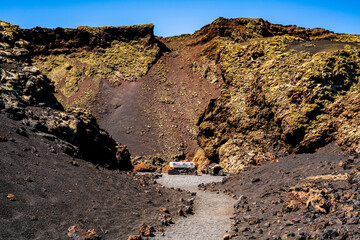 Entrance to the crater of the raven volcano and the sea of ​​lava solidified around it. Photography made in Lanzarote, Canary Islands, Spain.