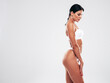 © halayalex - High fashion portrait of young beautiful sexy woman in white lingerie swimwear. Carefree model with perfect body. Hot tanned female isolated on grey in studio in summer swimsuit