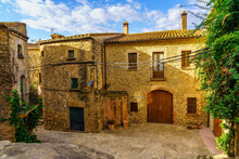 Idyllic Stone Buildings With Climbing Plants And Wooden Doors In The Medieval Village Of Madremanya, Girona, Catalonia.