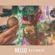 Composition of hello december text over christmas baubles and hand