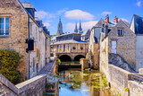 Fototapeta Uliczki - Bayeux, Normandy in northwestern France. The historic centre, the Notre Dame Cathedral and the Aure river.
