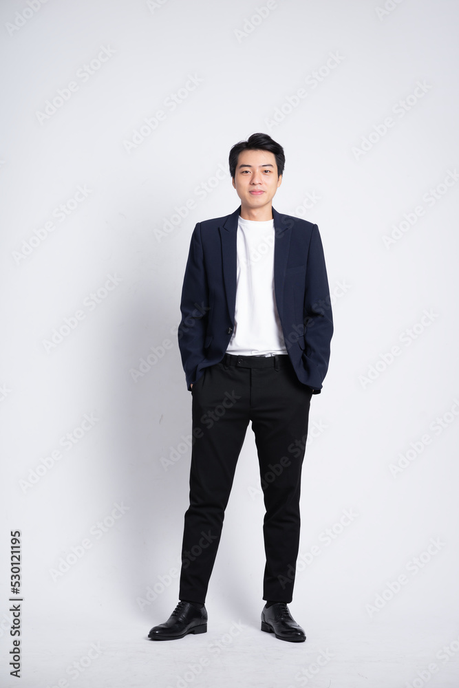 Young business man wearing a suit posing on a white background Stock ...