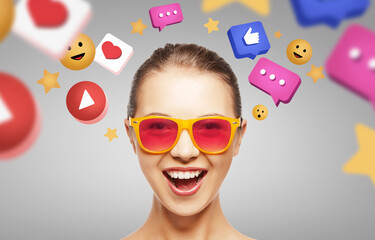 social media and people concept - happy teenage girl in sunglasses over internet icons on grey background