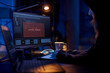 © Syda Productions - cybercrime, hacking and technology concept - close up of female hacker in dark room breaking security system or using computer virus program for cyber attack