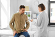 © Syda Productions - medicine, healthcare and people concept - female doctor showing prescription to man patient at hospital