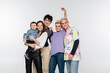© LIGHTFIELD STUDIOS - happy lesbian woman holding toddler boy near lgbtq community friends isolated on grey.