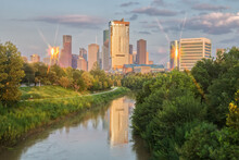 Houston Skyline Reflected In Bayou During Golden Hour With Eight Point Star On Buildings From Sunlight