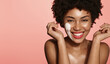 Happy woman washing her face with cleansing foam, hydrating her skin, smiling and laughing, standing over pink background