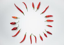 Red Chili Pepper Laid Out In A Circle On A White Background.