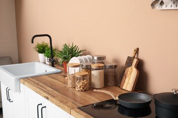 Canvas Print - Cutting boards and jars with food on counters near beige wall