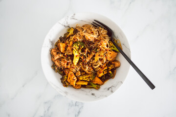 Wall Mural - healthy vegan food, broccoli and plant-based chicken stiry fry with vermicelli noodles