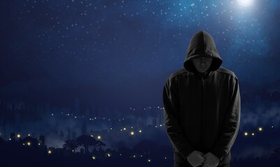 Silhouette of man in hoody on space and stars background