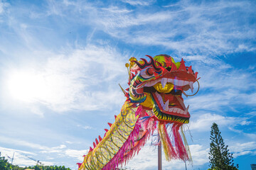 A head of Chinese Dragon dance in the Chinese new year festival. Lion and dragon dance during Chinese New Year celebration. Group of people perform a traditional lion dance.