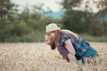 Wall Mural - Loving couple in a wheat field.