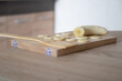 © Aleksander - Sliced banana on a wooden board. Healthy food, cooking process in the kitchen