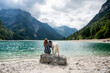 © mooseshop - Woman enjoying the mountains view wit Russian wolfhound dog at lakeside in Italy