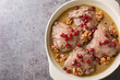 Delicious chicken stew in pomegranate walnut sauce close-up in a plate on the table. Horizontal top view from above