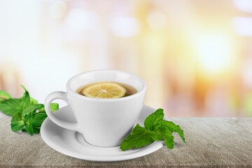 Poster - Ice tea with mint in cup with fresh mint leaves around. Homemade cold refreshing drink.