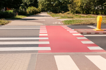 Wall Mural - Bicycle lane with painted white sign and pedestrian crossing outdoors