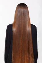 A Woman From The Back With Very Long Brown Hair.