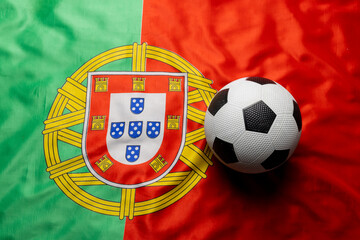 Composition of football over national flag of portugal