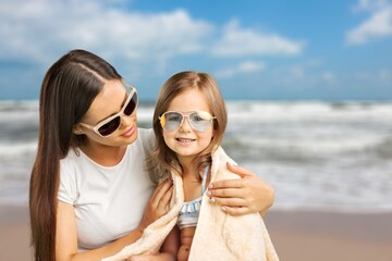 Wall Mural - Shot of a woman spending the day at the beach with adorable child.