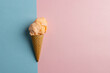 Horizontal image of orange homemade ice cream in cone, on blue and pink with copy space