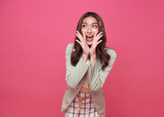 Young Asian teenage girl surprised excited isolated on pink background.