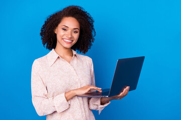 Poster - Portrait of pretty cheerful girl hands hold wireless netbook networking isolated on blue color background