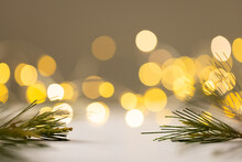 Image Of Pine Branches And Yellow Christmas Out Of Focus Fairy Lights In Background