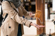 © PR Image Factory - cropped view of unrecognized female Asian Japanese worshipper cleaning hands to purify herself at temizuya water pavilion when visiting tenmangu shrine in osaka japan.