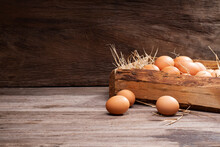 Chicken Eggs Are Laid On The Ground And Put In A Basket On A Wooden Table On, A Rural Farm