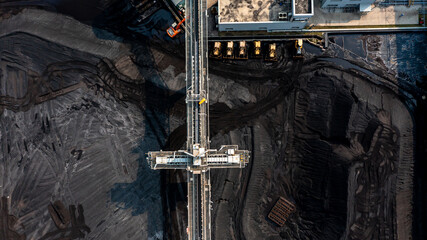 Canvas Print - Aerial top view moving belt with heap of coal next to the coal power plant, Coal mining view from above,