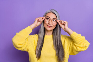 Photo of good mood cunning business lady in eyeglasses look blank space brainstorming isolated on purple color background
