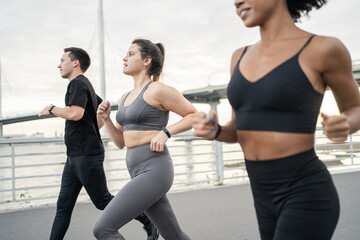 Wall Mural - Group of friends training fast running in sportswear.