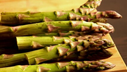 Wall Mural - bunch of asparagus close up on wooden board