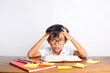 © ArvStd - Confused asian schoolboy studying in classroom while holding his head. Isolated on white background