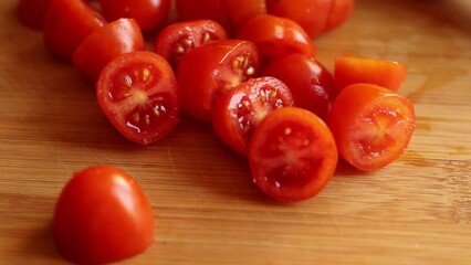 Wall Mural - cutting cherry tomatoes at home on wooden board