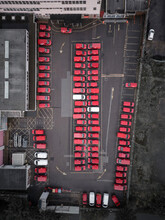 Aerial View Of Red Vans Parked In A Car Park