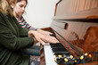 A music teacher teaches a girl to play the piano, they start playing four hands together, the focus is on the hands of the teacher, the concept of music education that develops the personality