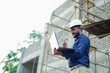 © Ashutosh khandale - young Indian engineer in uniform and using laptop at field