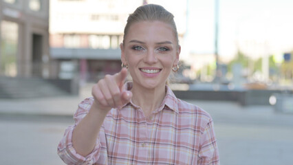 Young Woman Pointing at the Camera Outdoor