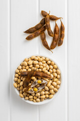 Sticker - Soy beans. Dried soybean pod in bowl on white table.