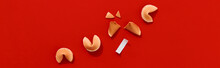 Fortune Cookies On Red Background With Deep Long Shadows. Blank Paper For Prediction Words
