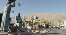 Downtown Palm Springs. California Panning Around Art Sculptures On Side Of Road With Desert Mountains In Backdrop On Sunny Day