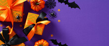 Halloween Banner Template. Flat Lay Gift Boxes With Ribbon Bow, Bats, Spiders, Pumpkins And Confetti On Purple Background. Halloween Sale, Discount, Special Offer Concept.