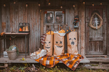 Photo Zone For Halloween With Festive Handmade Paraphernalia. Kraft Paper Bags Painted With Jack Pumpkin Grimace, Monsters Decorations For Halloween