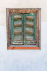 Wall Mural - Old wooden window with closed lattice shutters. Vertical.